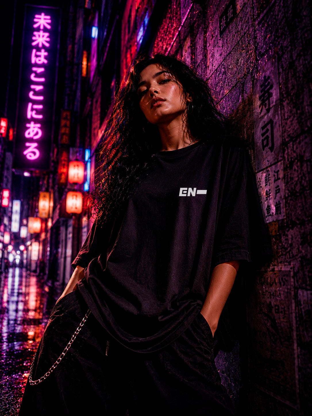 Drip&Verse black oversized cotton K-Pop tee with a minimalist white logo on the front, worn by a model in a neon-lit alley.