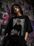 Drip&Verse black oversized cotton tee with a graphic print of a man and vertical text reading "LOW TIDE IN TWILIGHT".