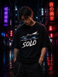 Drip&Verse black 100% cotton oversized tee with anime-style blue eyes and "SOLO" graphic. Model wears size M.