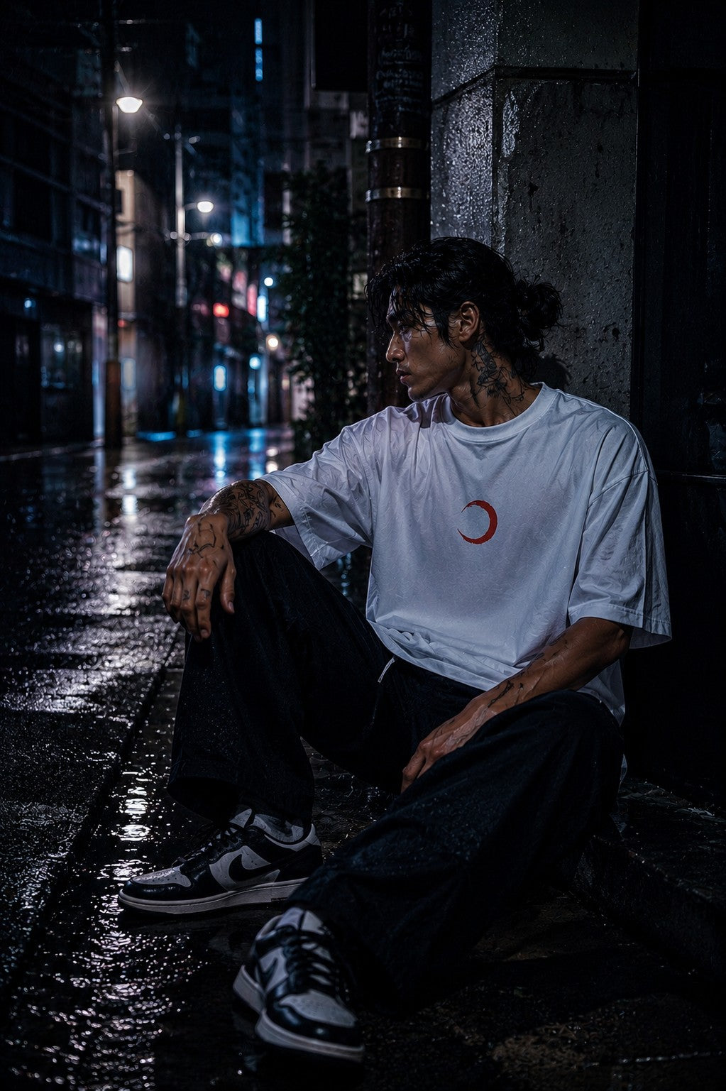 Drip&Verse white 100% cotton oversized tee with a red crescent moon graphic on the chest, worn by a tattooed man in dark pants.